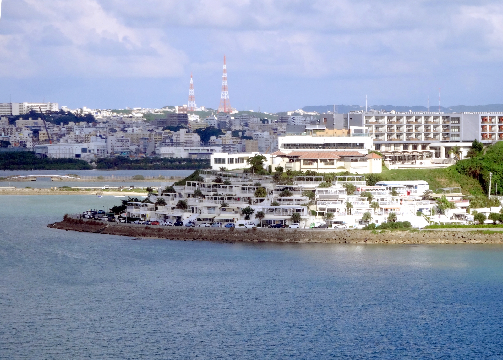 隔著海面遠望瀨長島海風露台的白色建築群